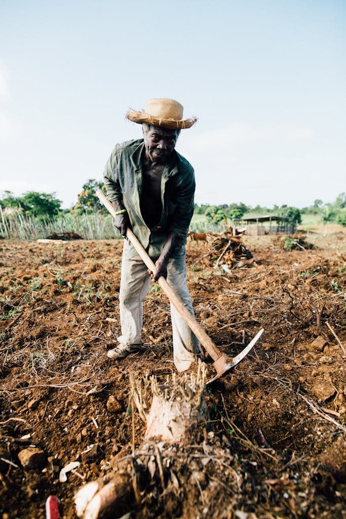 Photo of Man Standing While Holding Pickaxe